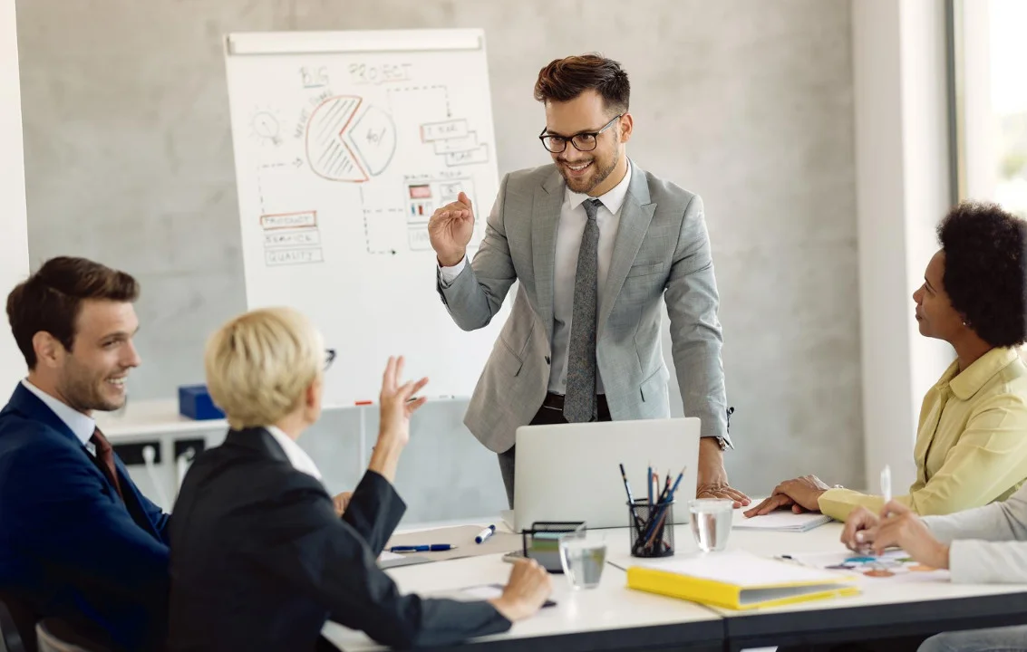 Businessman giving presentation to other business people